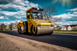 Road roller rolling new hot asphalt on the new road. Road construction.