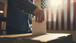 essence of democracy as a man exercises his right to vote, depicted in a close-up shot of him inserting his ballot into a polling box, with the United States flag blending softly i