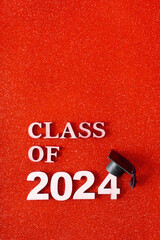 Wall Mural - Class of 2024 text with graduation cap on glitter background. Graduation holiday concept.