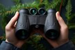 Hands holding binoculars on a Dark background