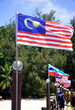 Kinabalu, Malaysia - August 8, 2022: Malaysian and Sabah flags alongside the pier of Marukan Island in Sabah, Malaysia