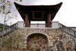 Viewing deck with pagoda inspired architecture and stairs on stone wall