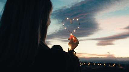 Wall Mural - silhouette of Girl with Heart symbol in the sky