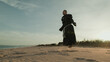 Religious Monk Does Jump Rope On The Soft Sand Beach