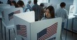© Framestock - Asian woman comes to vote in booth in polling station office. National Election Day in the United States. Political races of US presidential candidates. Concept of civic duty. Slow motion. Dolly shot.