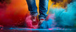 A person in red shoes is jumping in the air with colorful smoke around them