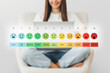 © Evgenia - pain measurement scale. Colorful set of emotion icons. A girl with a laptop checks her mood scale