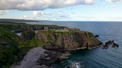 Wall Mural - aerial approach over cliff top castle on scotland coast. dunnottar castle.
