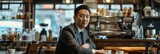 Fototapeta Na drzwi - Asian businessman performs multiple tasks in a cozy coffee shop