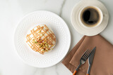 Fototapeta  - Cinnamon roll bun with icing on plate