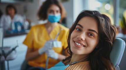 Dentistry hospital. Live photo of a laughing woman at the dentist's appointment. Beautiful girl visit dental clinic, check up teeth. Person patient treat tooth. Woman dentist at background.