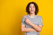 Photo of nice young man direct finger empty space wear striped t-shirt isolated on yellow color background