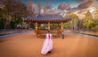 Asian korean Girls dressed Hanbok in traditional dress at sunset in South Korea.