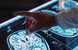 A doctor points to a brain scan on a computer screen. A close up of a brain with a hand pointing to a specific area.