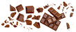  Levitating milk chocolate chunks isolated on white background. Crumbs, shavings and Flying Chocolate pieces Top view. Flat lay.