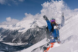 Fototapeta  - Woman snowboarder riding on slope of powdery snow in high mountains. Freeride at ski resort, Snow splashes trail,  mountain peaks view