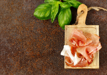 Poster - prosciutto ham on a wooden board with basil