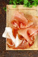 Poster - prosciutto ham on a wooden board with basil