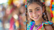 © Wilasinee - A young girl with a beaming smile wearing vibrant traditional clothing and accessories at a cultural festival.