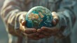 A person holding a globe with care and concern, symbolizing the need for global awareness and action to protect our planet.