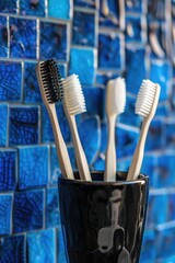 Wall Mural - Three toothbrushes in a cup on a counter, perfect for dental hygiene concept