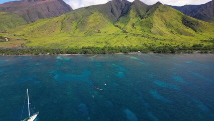 Wall Mural - kayakers and sailing boat explore coral reefs in the shallows of maui coast, hawaii.