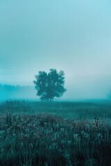 Poster - A solitary tree standing in a field of tall grass. Suitable for nature and landscape themes