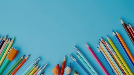 Poster - Group of colored pencils on a blue background. Ideal for educational or artistic concepts