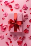Fototapeta Tulipany - A white gift box with a red ribbon and scattered rose petals, perfect for romantic occasions