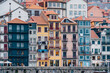 Porto, Skyline view of the old town of Portugal on the Douro river. Travel and monuments of Portugal. Old historic houses of Porto. Rows of colorful buildings in traditional architectural style.