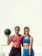 © peopleimages.com - Friends, women and medicine ball for fitness or workout in sportswear, exercise and healthy in New York. Portrait, training and confident with results in summer for wellbeing, wellness and outdoor