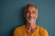 © MagnusCort - A man with gray hair and a yellow shirt smiles for the camera