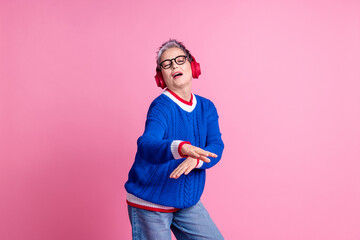 Poster - Photo of funky old woman wear headphones listen songs dance isolated pastel color background