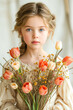 A portrait of a young girl with blue eyes holding a bouquet of orange tulips. Greetings of mother's day.