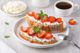 Fototapeta Młodzieżowe - Homemade Crispbread toast with Cottage Cheese and Strawberry on white wooden board