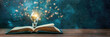 Open book with light bulb positioned on top of it, symbolizing ideas and inspiration