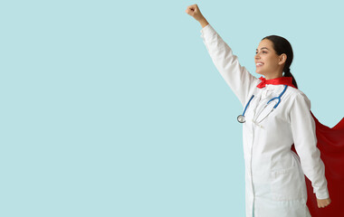 Poster - Beautiful female doctor dressed as super hero on blue background