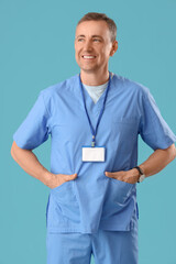 Poster - Mature doctor in medical uniform on blue background