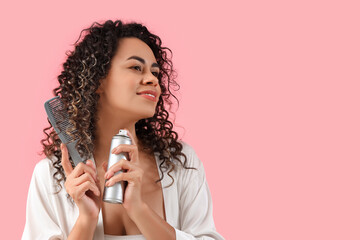 Poster - Beautiful African-American woman with hair spray and comb on pink background