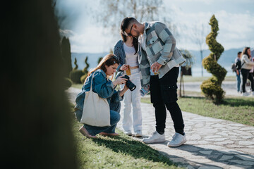 Wall Mural - A diverse group of friends gather in a park, engaging in conversation and enjoying photography on a bright, sunny day.