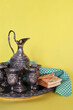 Traditional drinks set with crackers and a jug on a yellow background