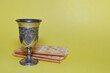 Crackers and silver wine goblet on a yellow background
