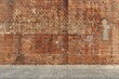 a large, uniform brick wall The bricks are uniformly sized and are laid in an offset pattern, typical of traditional brick laying techniques