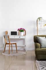 Wall Mural - Vase with tulips and laptop on table in living room interior