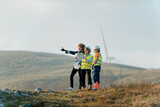 Fototapeta  - A team of engineers and workers oversees a wind turbine project at a modern wind farm, working together to ensure the efficient generation of renewable energy