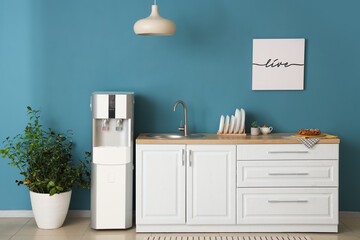 Sticker - Interior of stylish kitchen with modern water cooler near blue wall