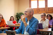 © ADDICTIVE STOCK - Lifelong learning concept with senior adult in class