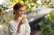 © SHOTPRIME STUDIO - Relaxation in Nature Woman Enjoying a Refreshing Glass of Healthy Kombucha in Sunlight Experience the detoxifying and antioxidant benefits of this organic drink as the young woman happily holds the