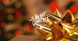 Golden ribbon adorning gift, with Merry Christmas text in focus