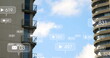 Social media icons and numbers hover over skyscraper under blue sky